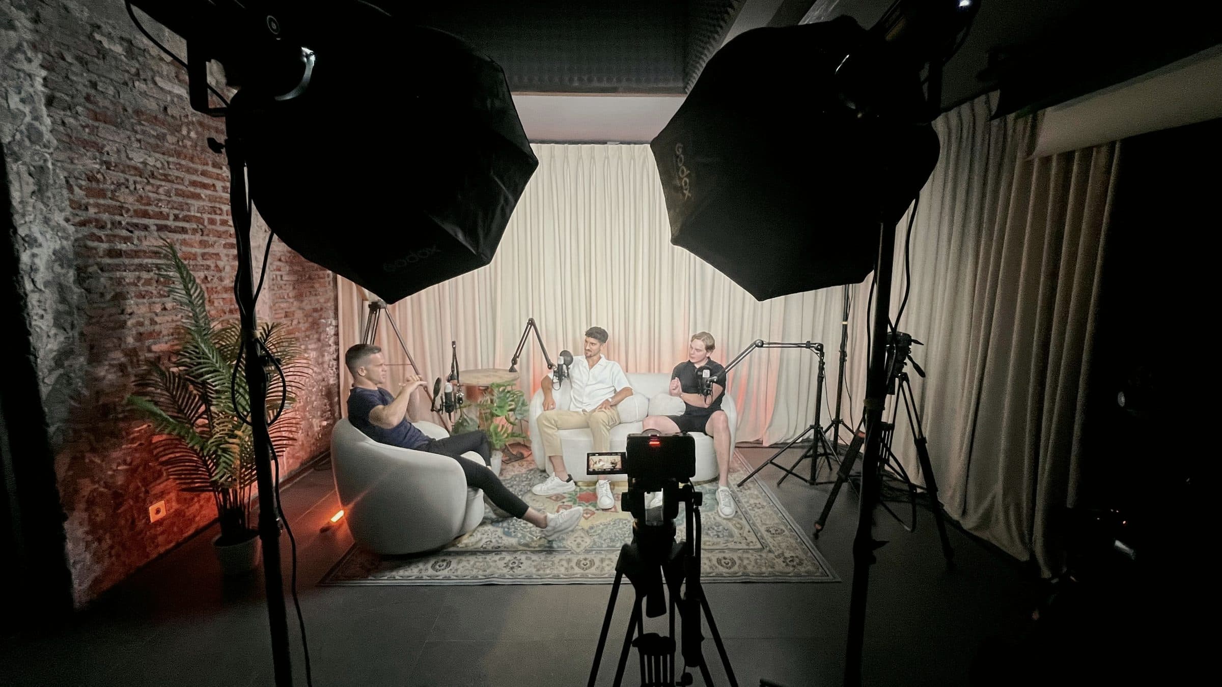 The studio set between takes: lights, cameras and three chairs.